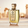 D'olcezza Extrait de Parfum by Unique’e Luxury in a warm golden setting with architectural background