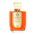A bottle of Unique'e Luxury Istanbul perfume with a gold-colored cap and a label indicating it is an extract de Parfum.