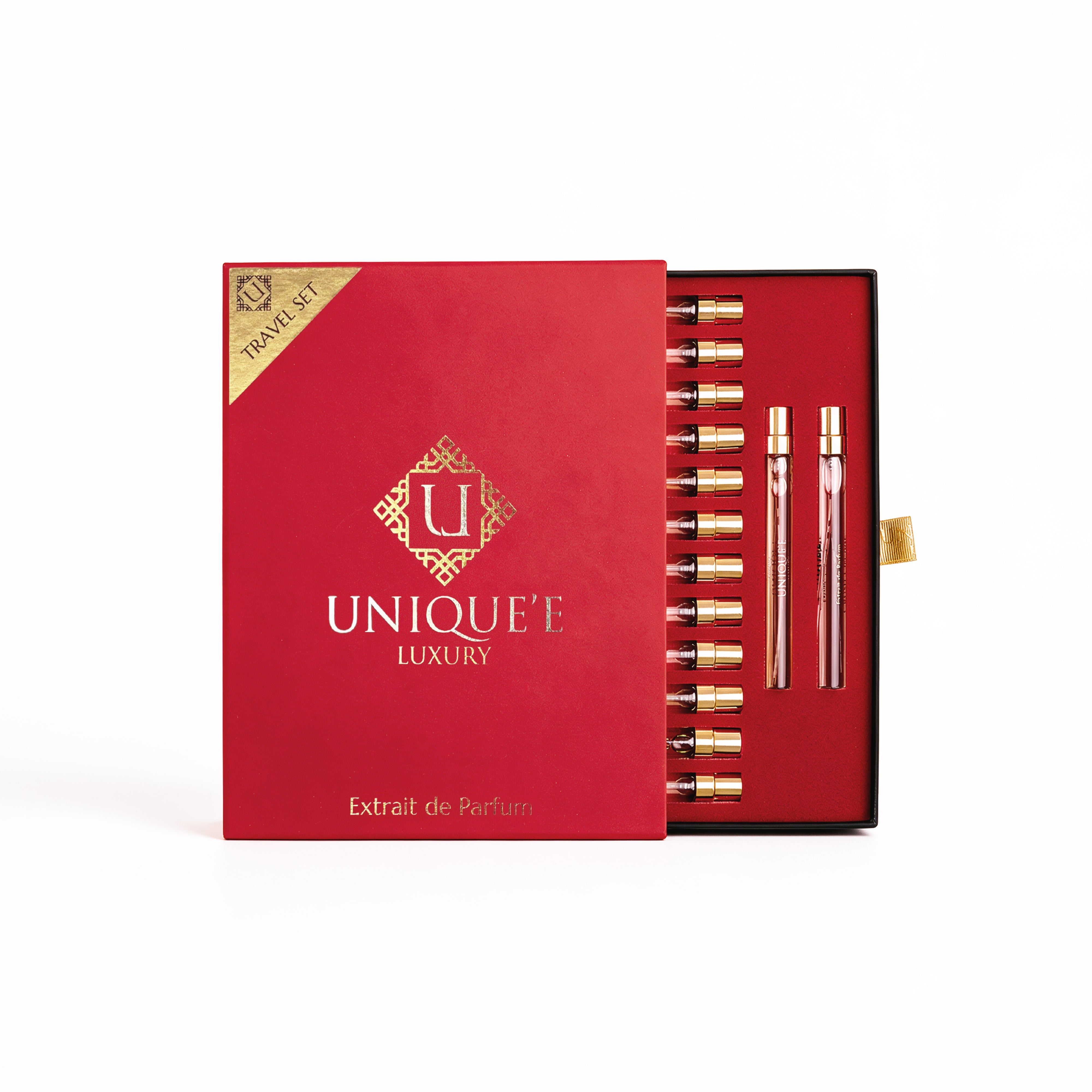 A luxury perfume travel set in a red box with gold detailing, shown open to reveal multiple small perfume vials and two larger bottles. The box features the brand name 'UNIQUE' LUXURY' and the text 'Extrait de Parfum'.